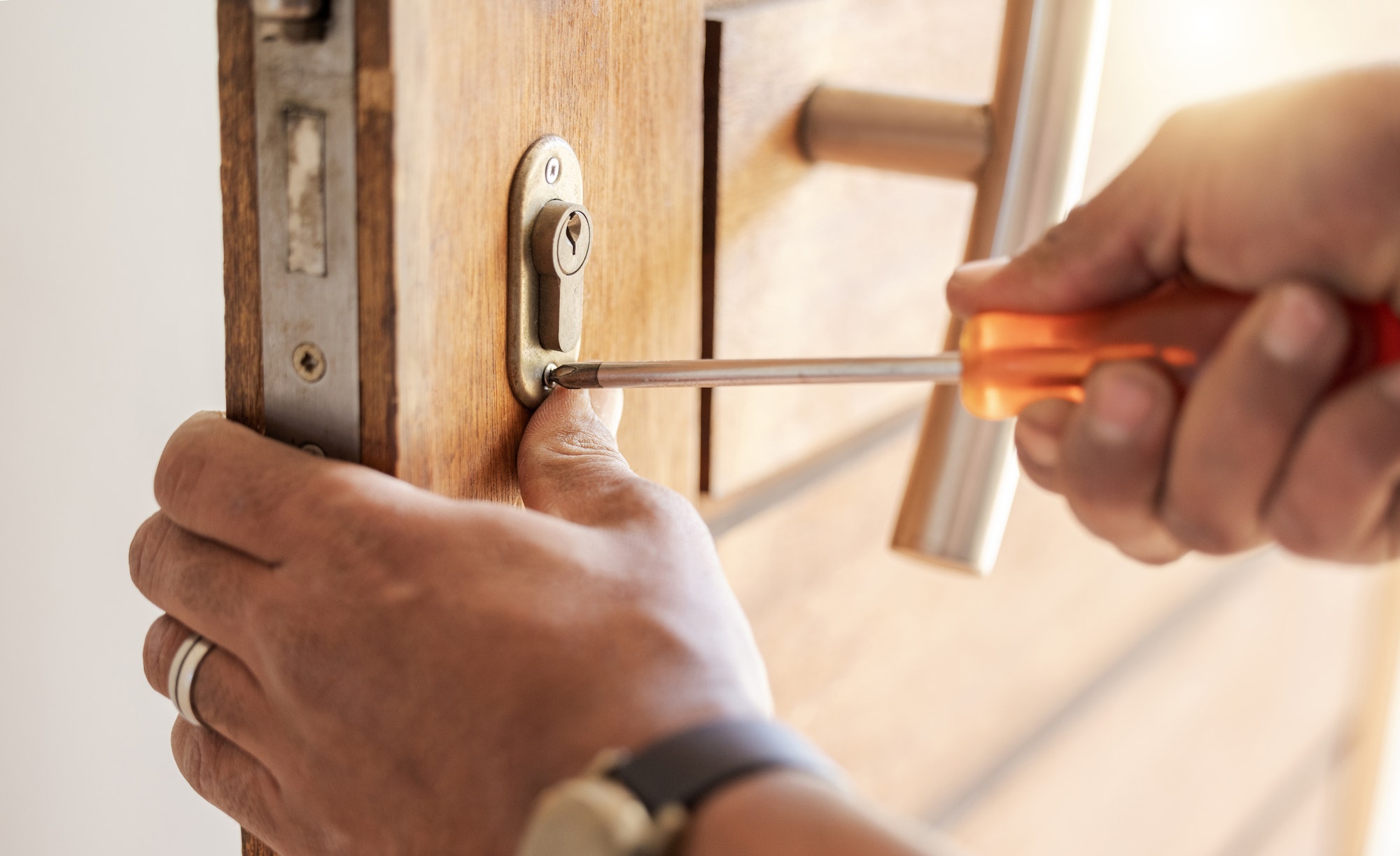 Locksmith hands, maintenance and handyman with tools, home renovation and fixing, change door locks